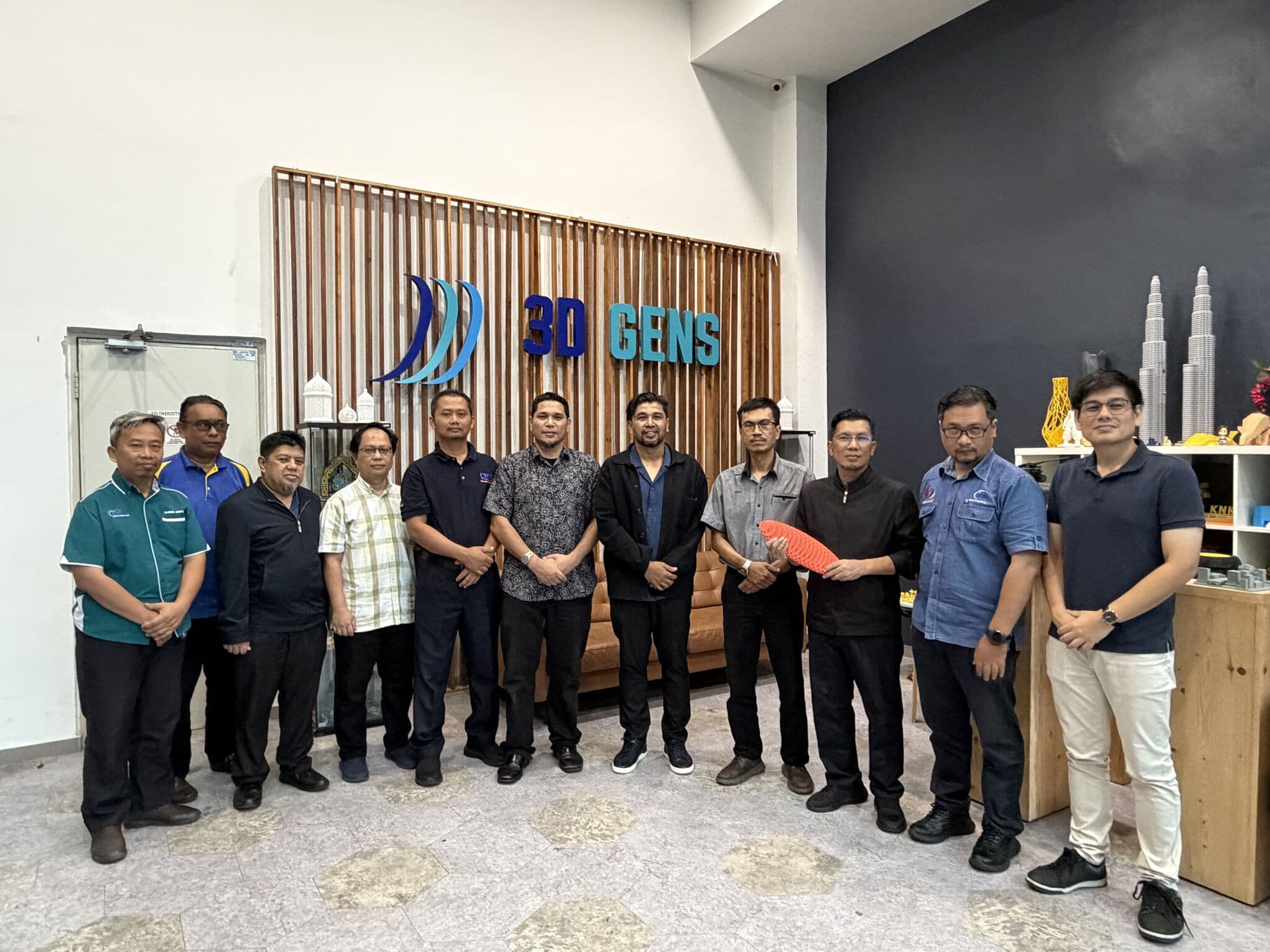 CIAST Master Trainer Programme participants holding a SLS polymer 3D printed part at the 3D Gens facility