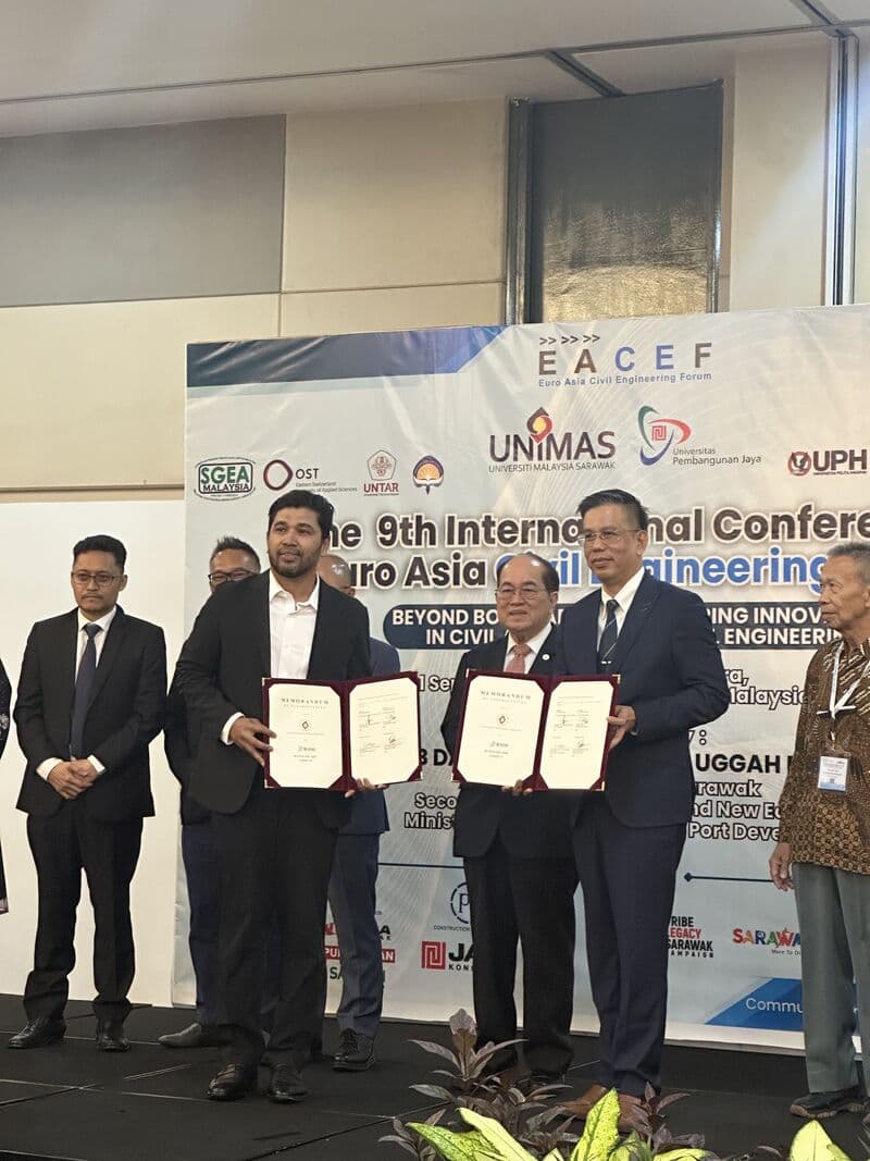 Close-up of 3D Gens and UNIMAS officials holding the signed Memorandum of Understanding at the EACEF conference